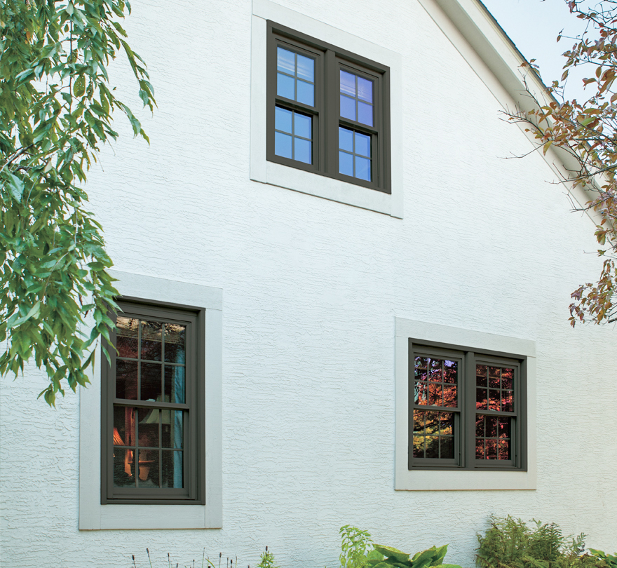 5500 Bronze exterior laminate on Double Hung windows with Colonial grilles